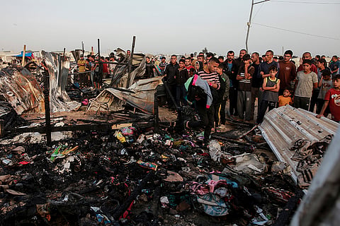 Palestinians look at the destruction
